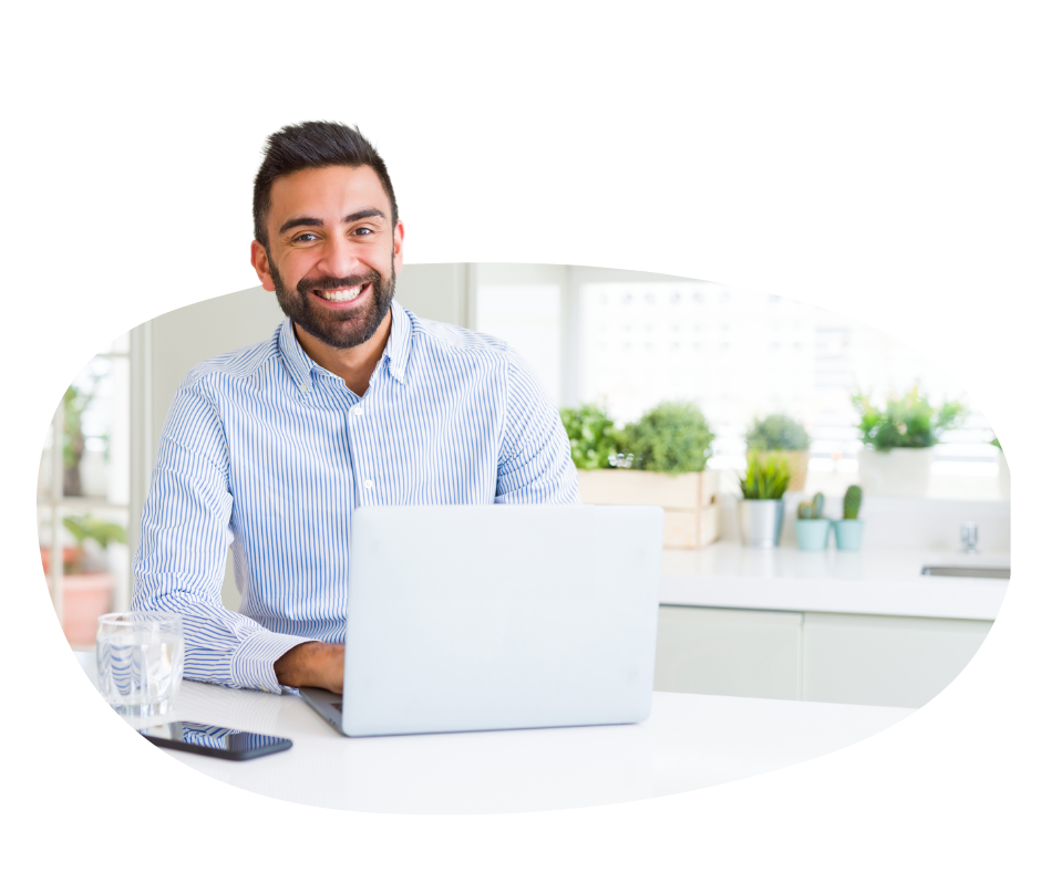 man smiling while on a laptop