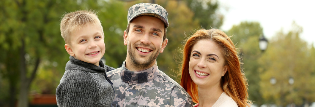 Military family smiling. Husband in service, wife and young boy. 